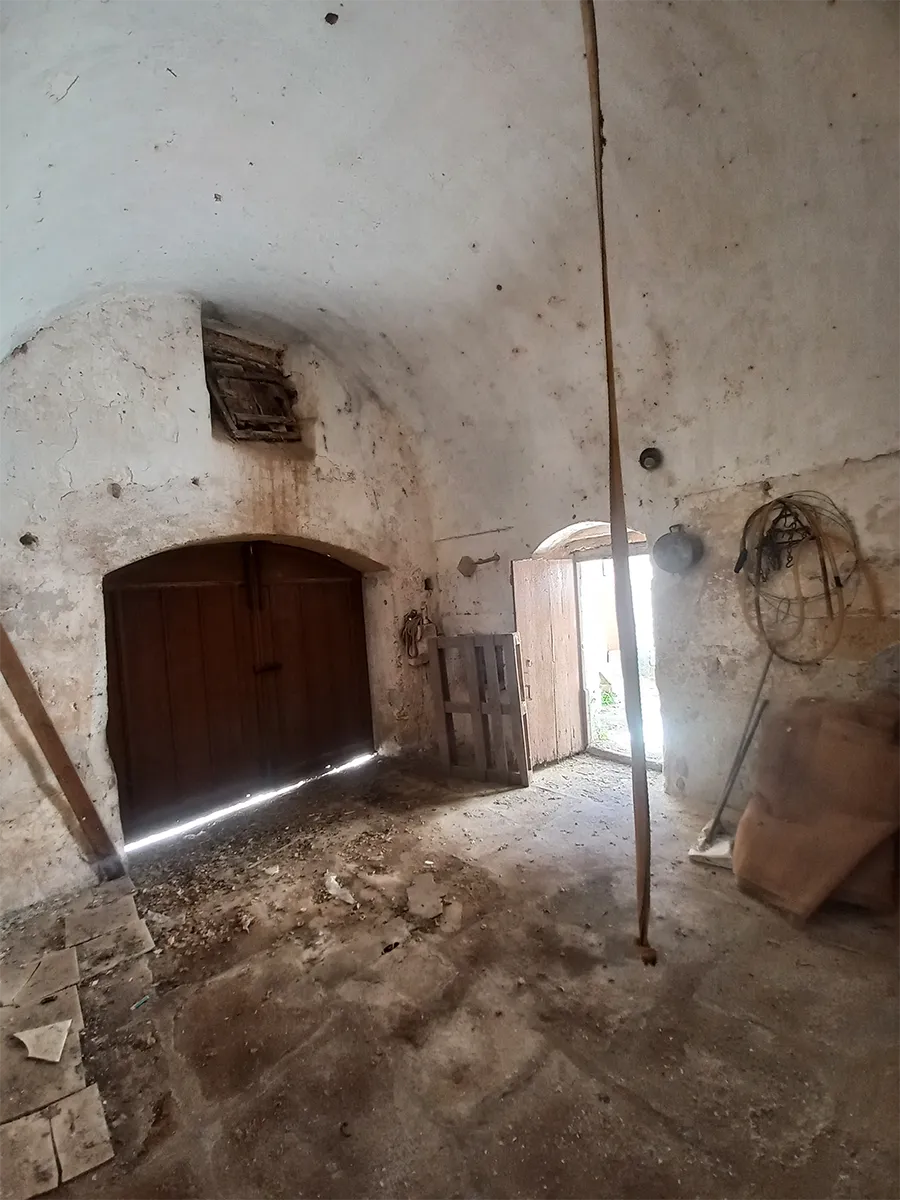 Details of the fully equipped kitchen featuring historic stonework and modern amenities - Before.