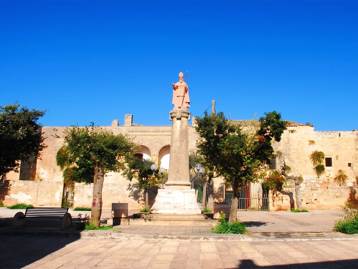 Sunlit historic stone facade in Giuliano di Lecce, Puglia.